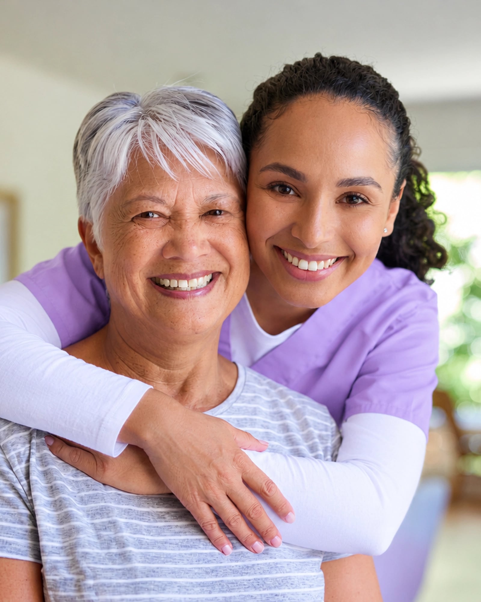 A caregiver sharing a relaxed moment with an older adult at home